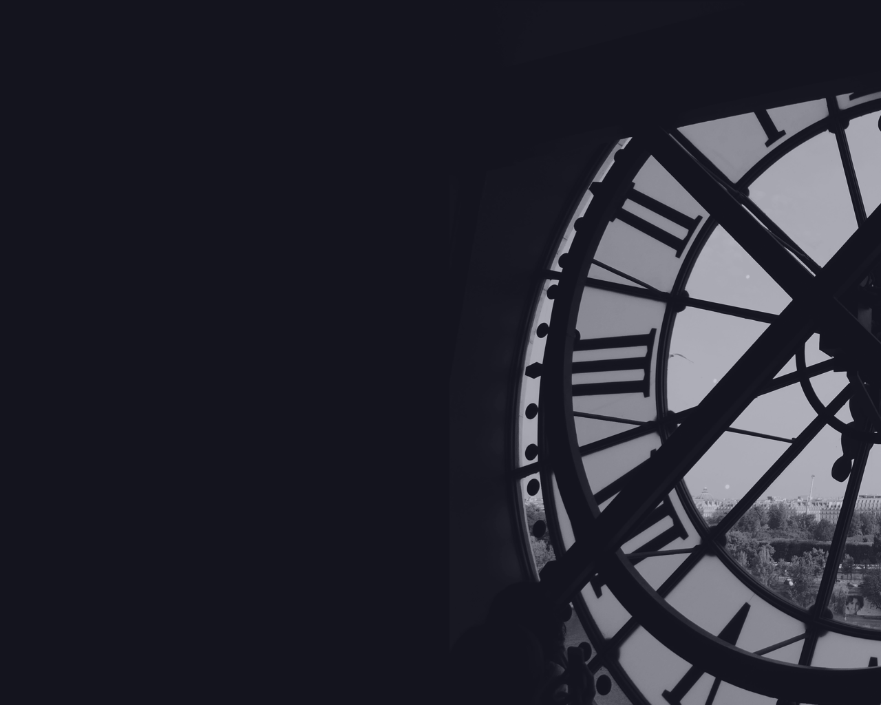 looking out to the town beneath from behind a large clock in a tower